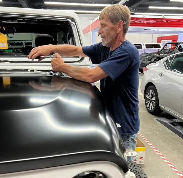 White Hat Collision Repair Car Technician Repairing a car